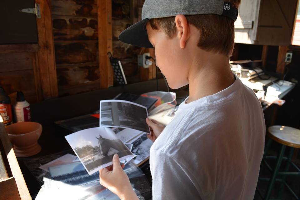 art camp student with photographs